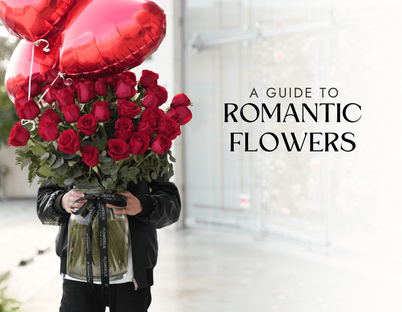 Large vase of red roses with heart-shaped balloons from Flowers.ie