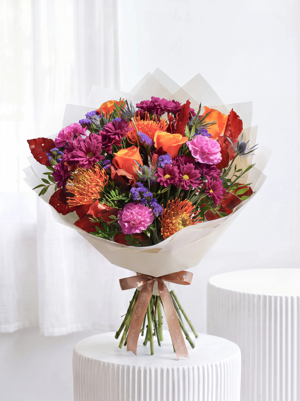 Large Amber Glow hand-tied bouquet of sunflowers, yellow and orange roses with blue and pink statice, Flowers.ie