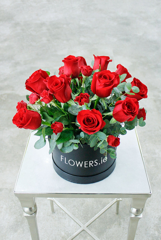 Dozen Red Deluxe Hatbox with Chocolates. Hatbox color may vary. Get fresh flowers from Flowers.IE. Same day flower delivery available.